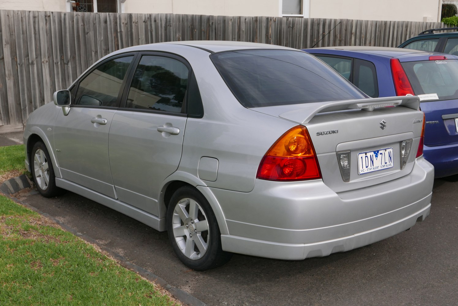 Silver sedan rear with spoiler and distinctive tail lights