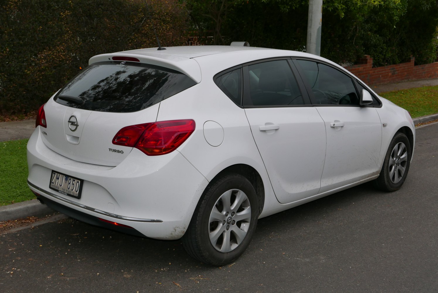 Rear and side profile of a turbo hatchback with distinctive tail lights.