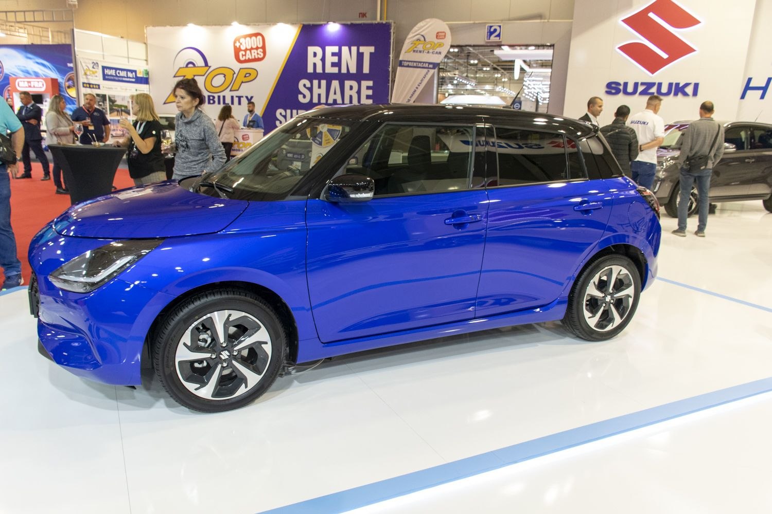 Blue hatchback with black roof and alloy wheels side profile