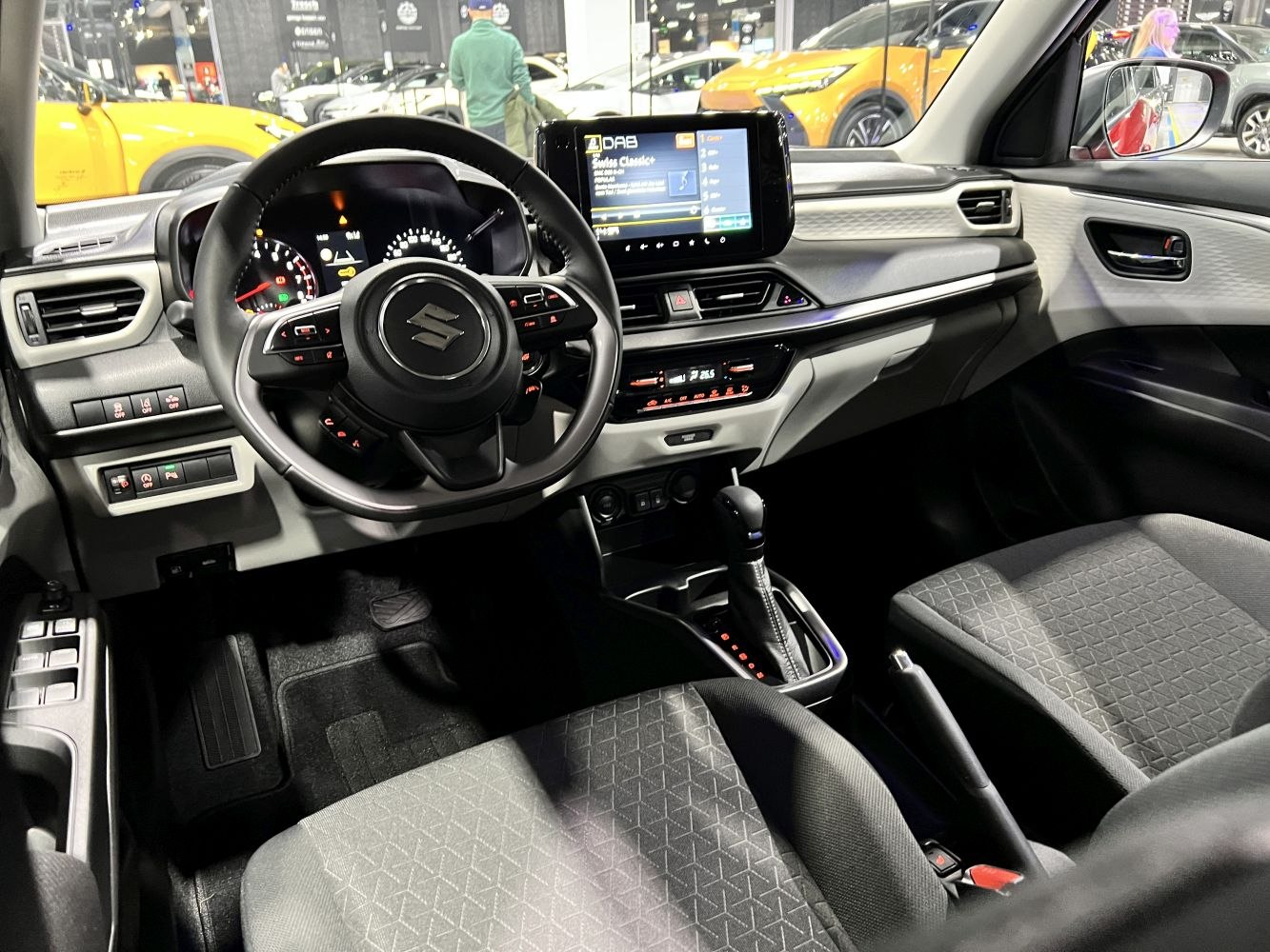 Interior view with steering wheel, digital dashboard, and infotainment center