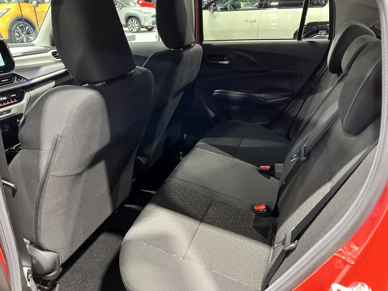 Rear interior seating and door panel with black fabric and seat belts
