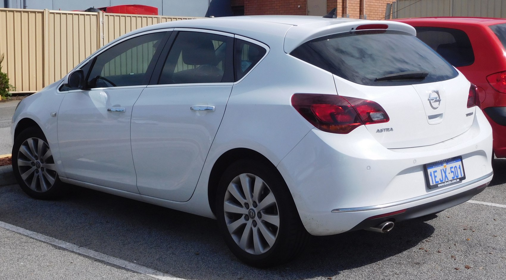 White five-door hatchback with rear taillights and alloy wheels