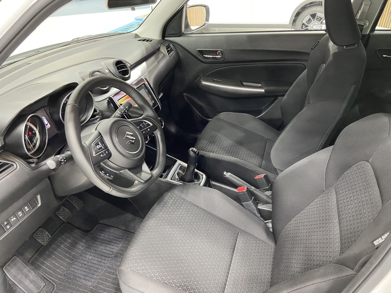 Car interior with steering wheel and manual gearbox