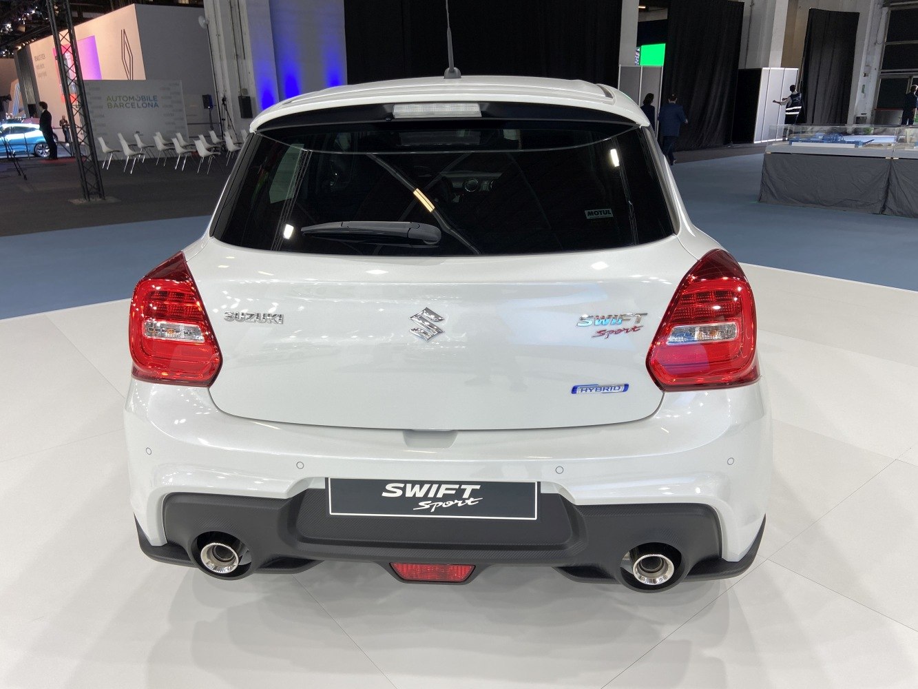 Rear view of a hatchback featuring hybrid badge and dual exhausts.