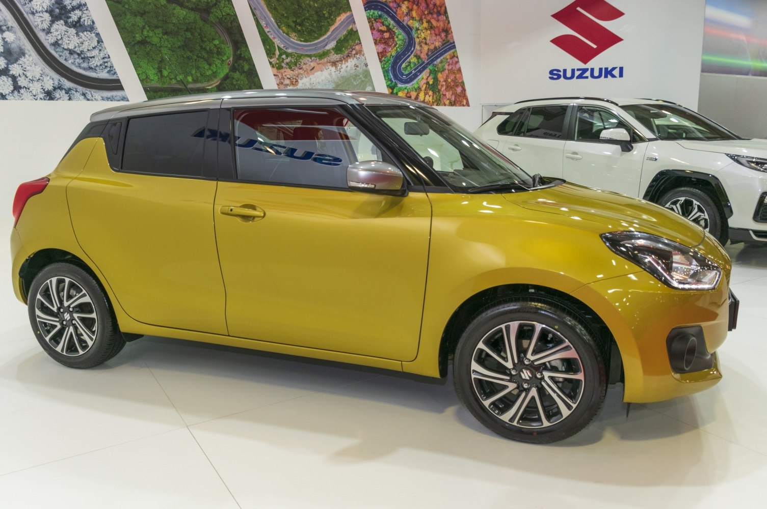 Side profile of compact hatchback with alloy wheels and two-tone paint.