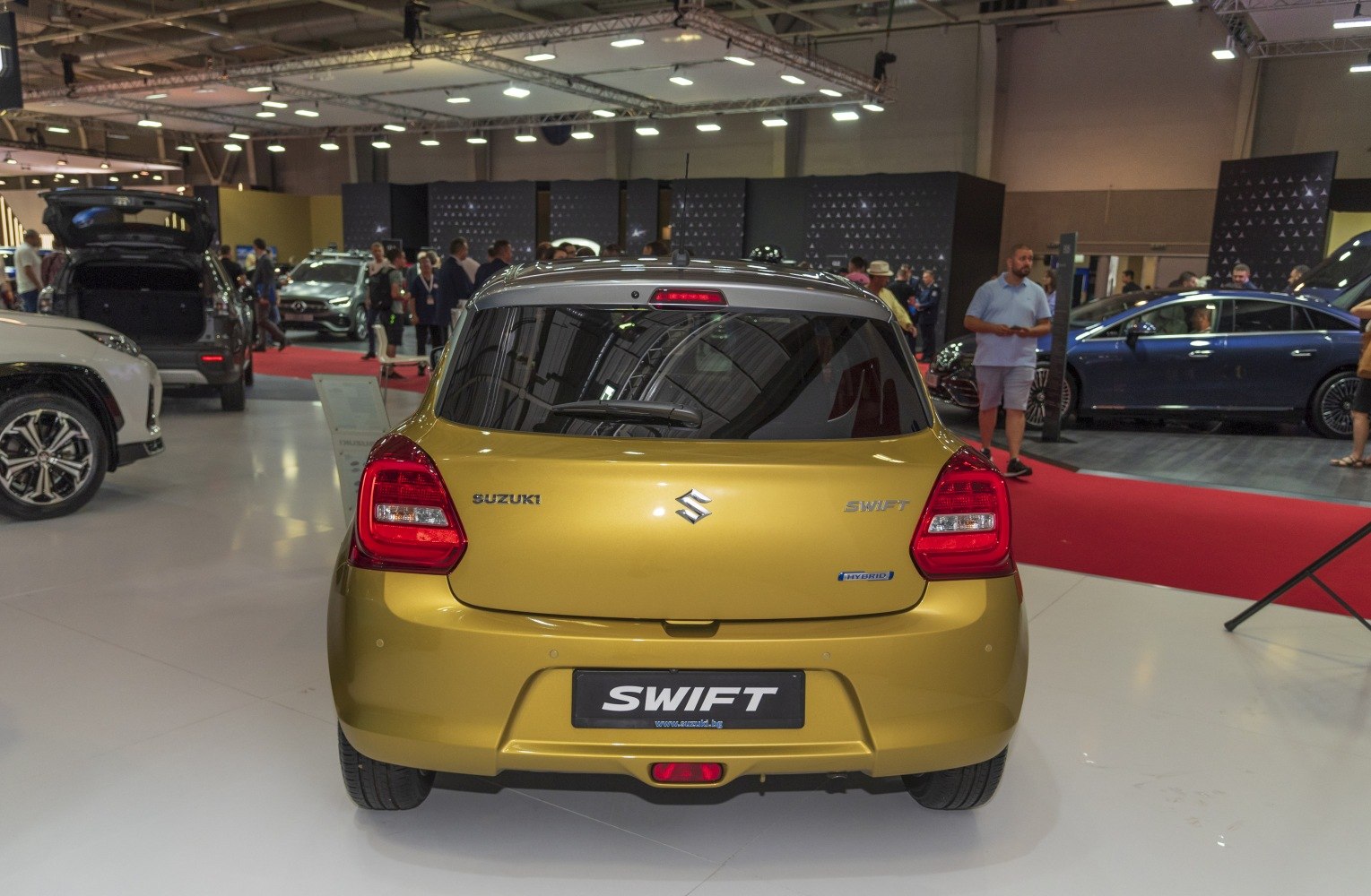 Rear view of a hybrid hatchback with distinctive taillights and rear window wiper.