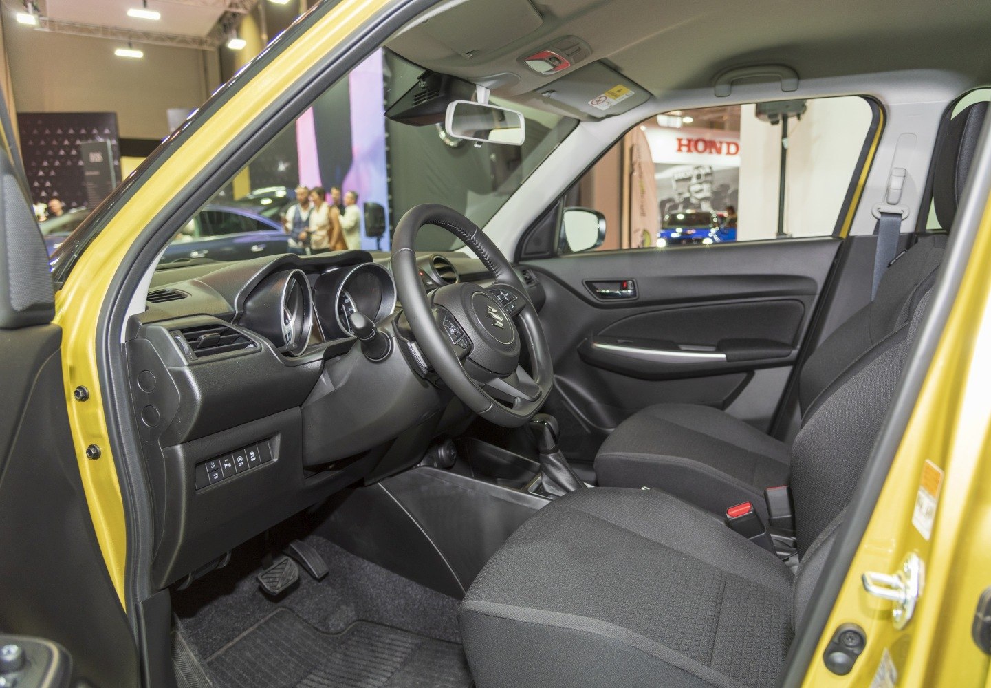 Modern dashboard and fabric front seats with steering wheel
