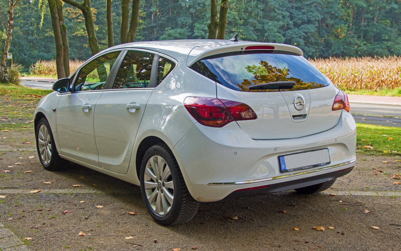 Rear and side view of a white hatchback with modern taillights and smooth body contours