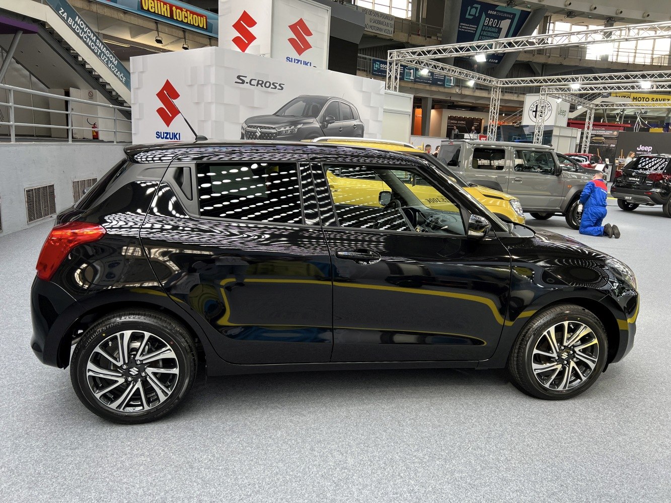 Side view of black compact hatchback with dual-tone alloy wheels