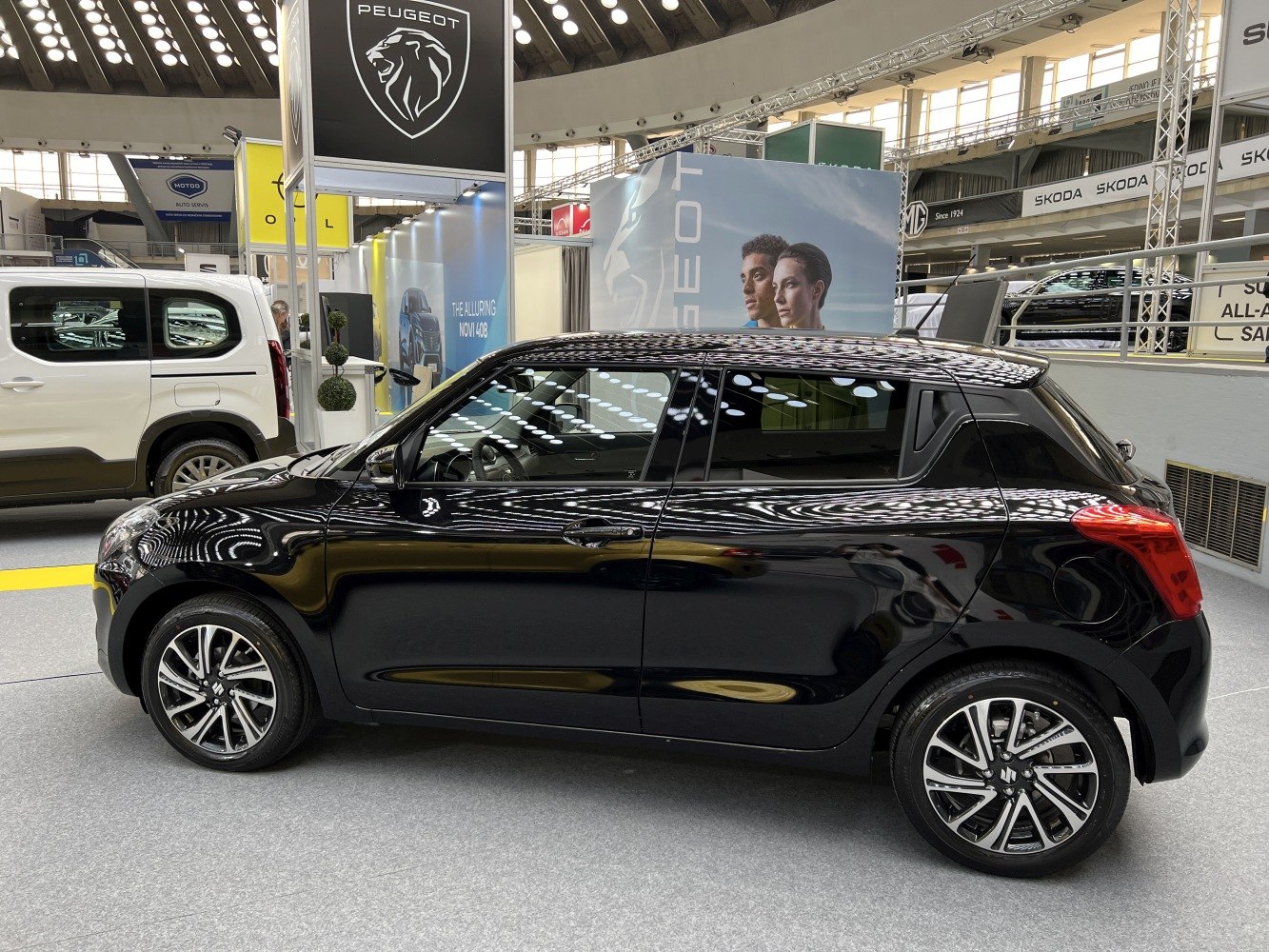 Black subcompact hatchback with alloy wheels and tinted windows