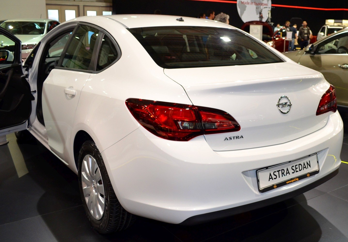 White sedan rear angle with distinct taillights and trunk design