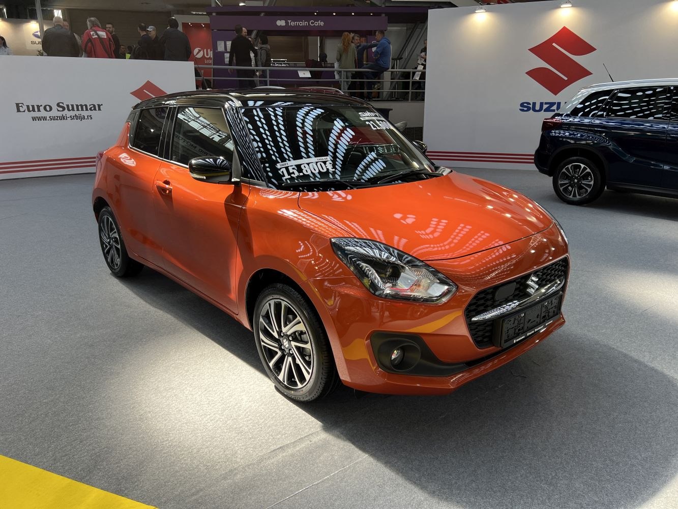 Orange compact hatchback with alloy wheels and LED headlights