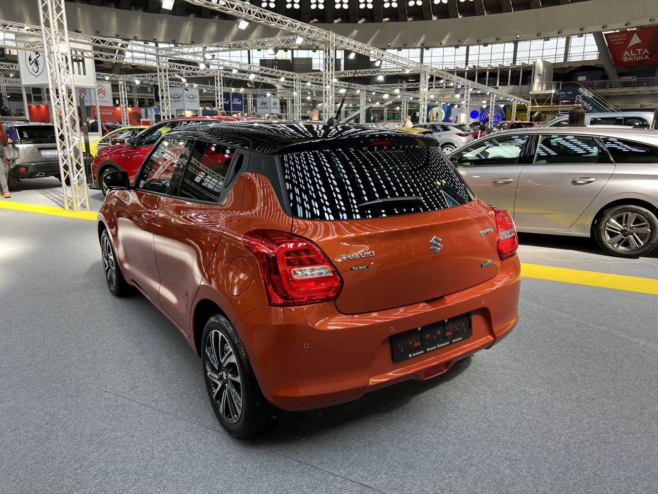 Rear view of compact hatchback with black roof and modern taillights