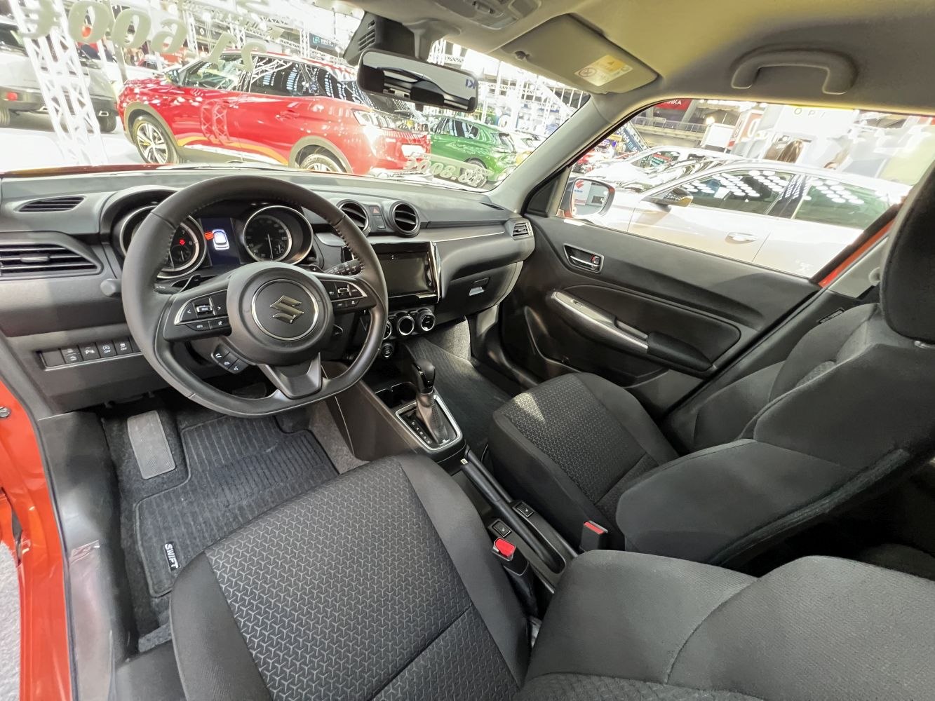 Dashboard, steering wheel, and front seats of a compact car interior
