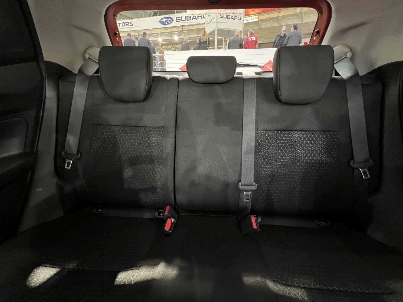 Rear seat interior with three headrests and seat belts