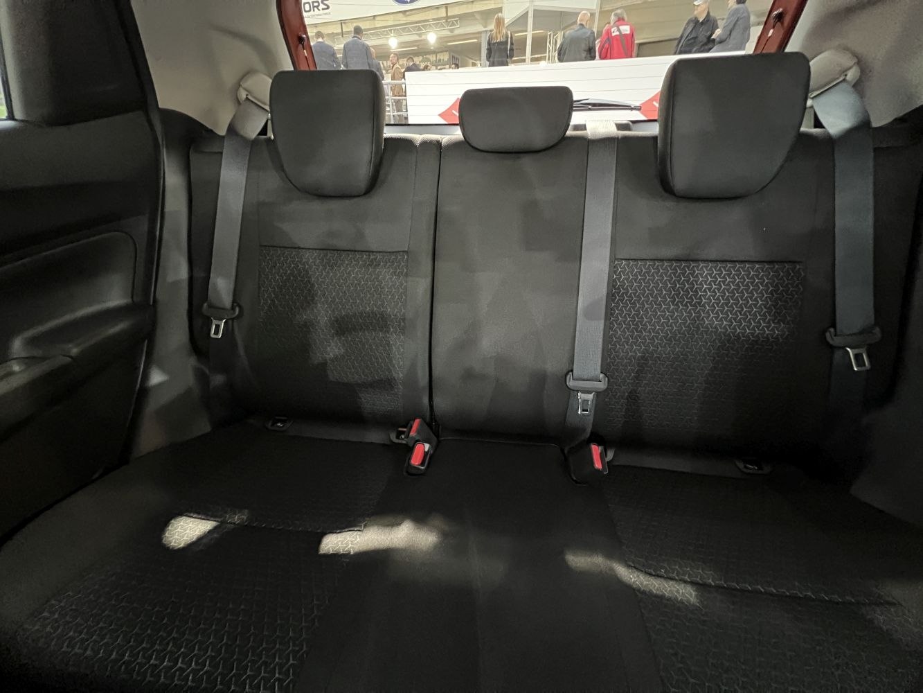 Rear seat with patterned upholstery and three headrests