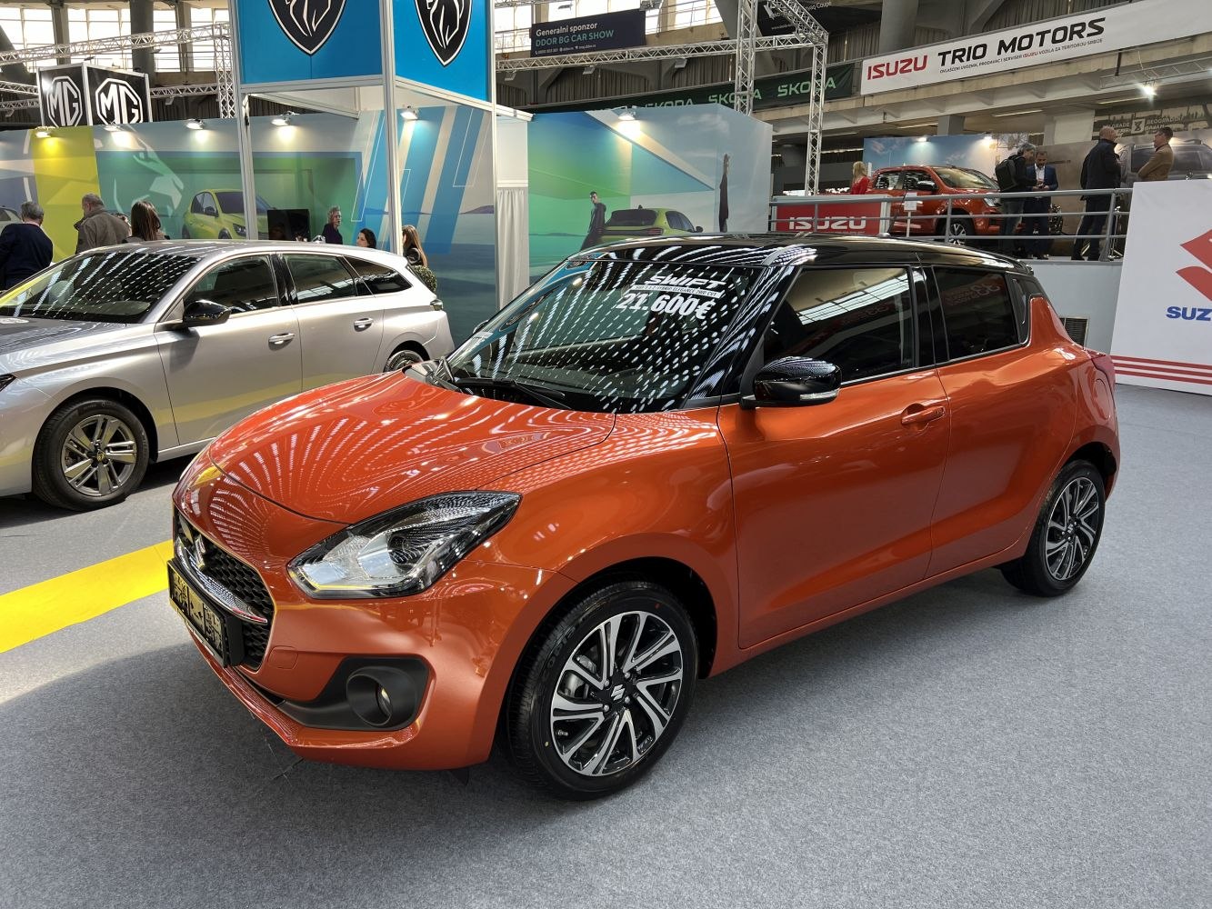 Orange compact hatchback with black roof and sporty alloy wheels