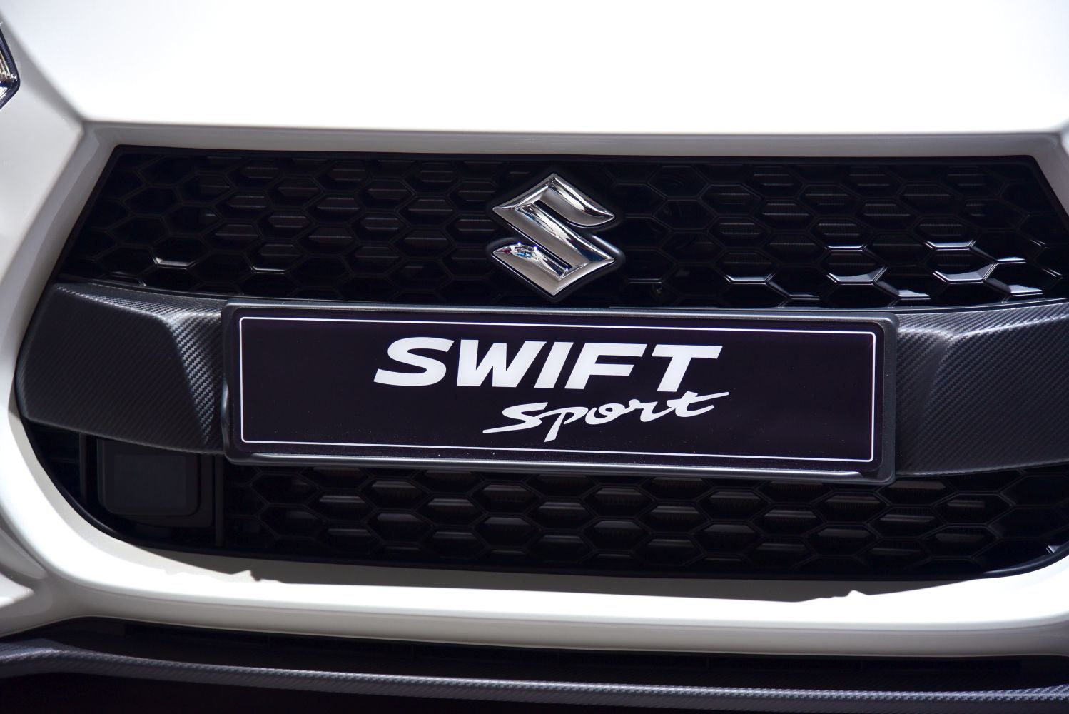 Close-up of sport front grille and badge with honeycomb pattern