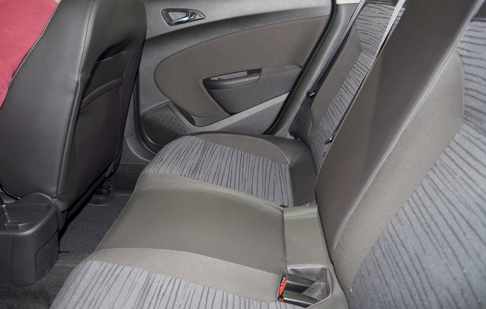 Rear seat with fabric upholstery and door panel in vehicle interior