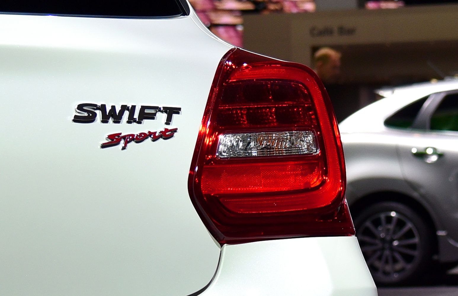 Close-up view of rear tail light and 'Swift Sport' badge