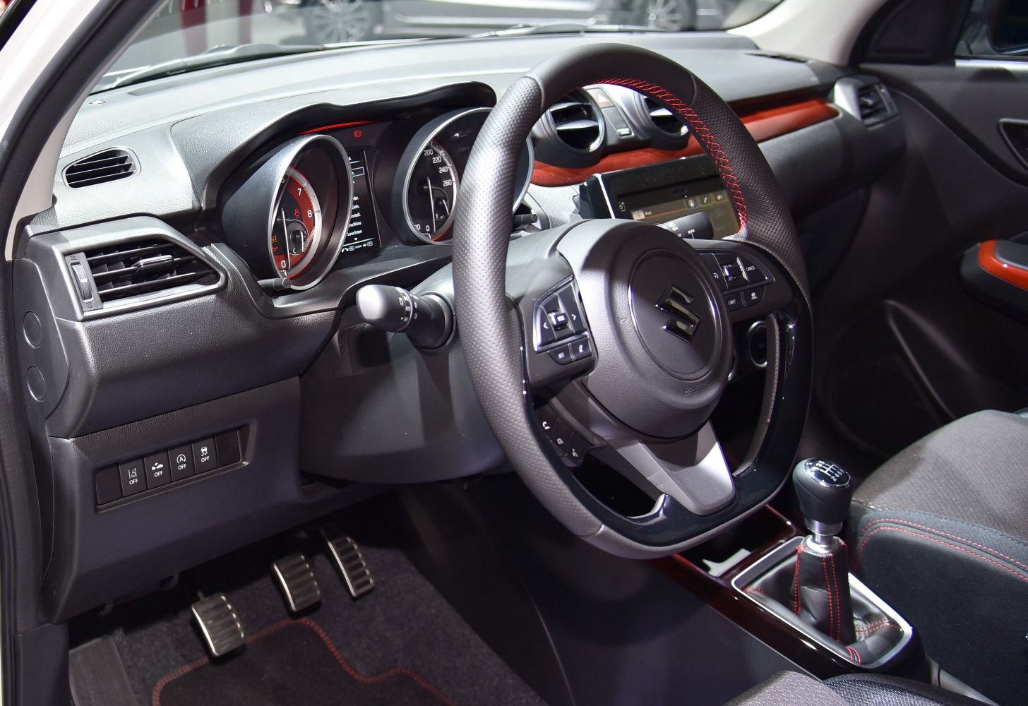 Steering wheel with controls, instrument cluster, manual gear shift, pedal area