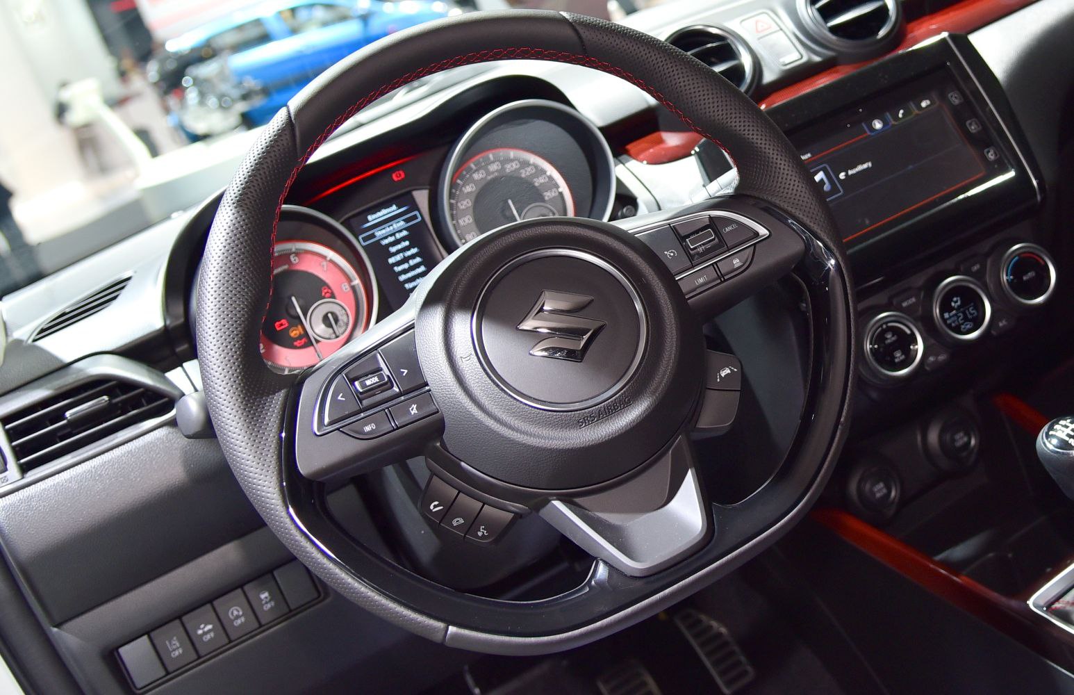 Steering wheel with controls and dashboard instrument cluster.