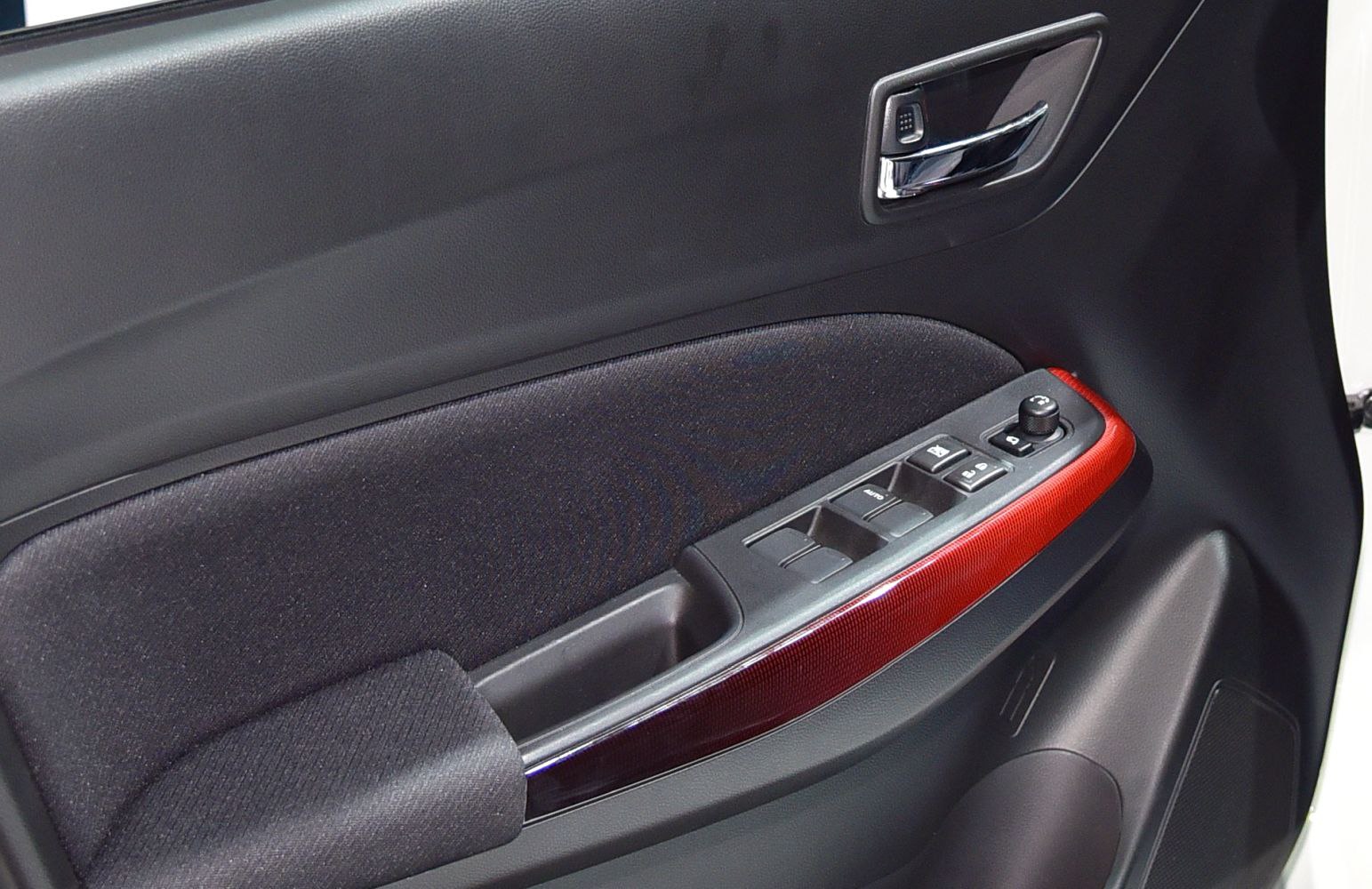 Interior door panel with control buttons and red trim