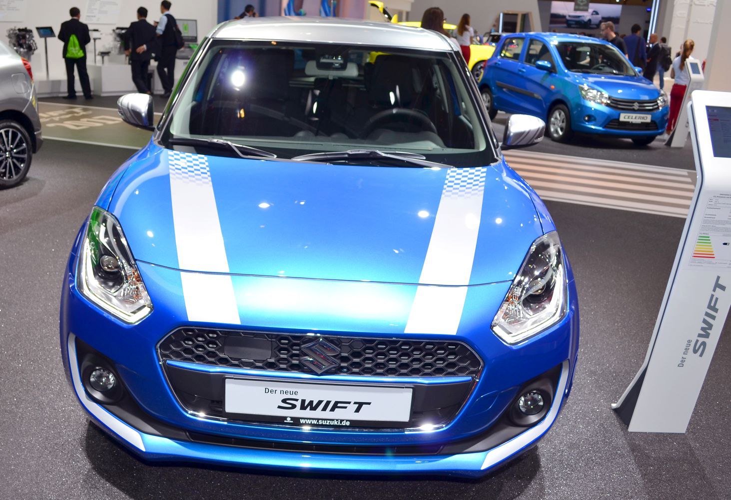 Close-up front view with white racing stripes and hexagonal mesh grille