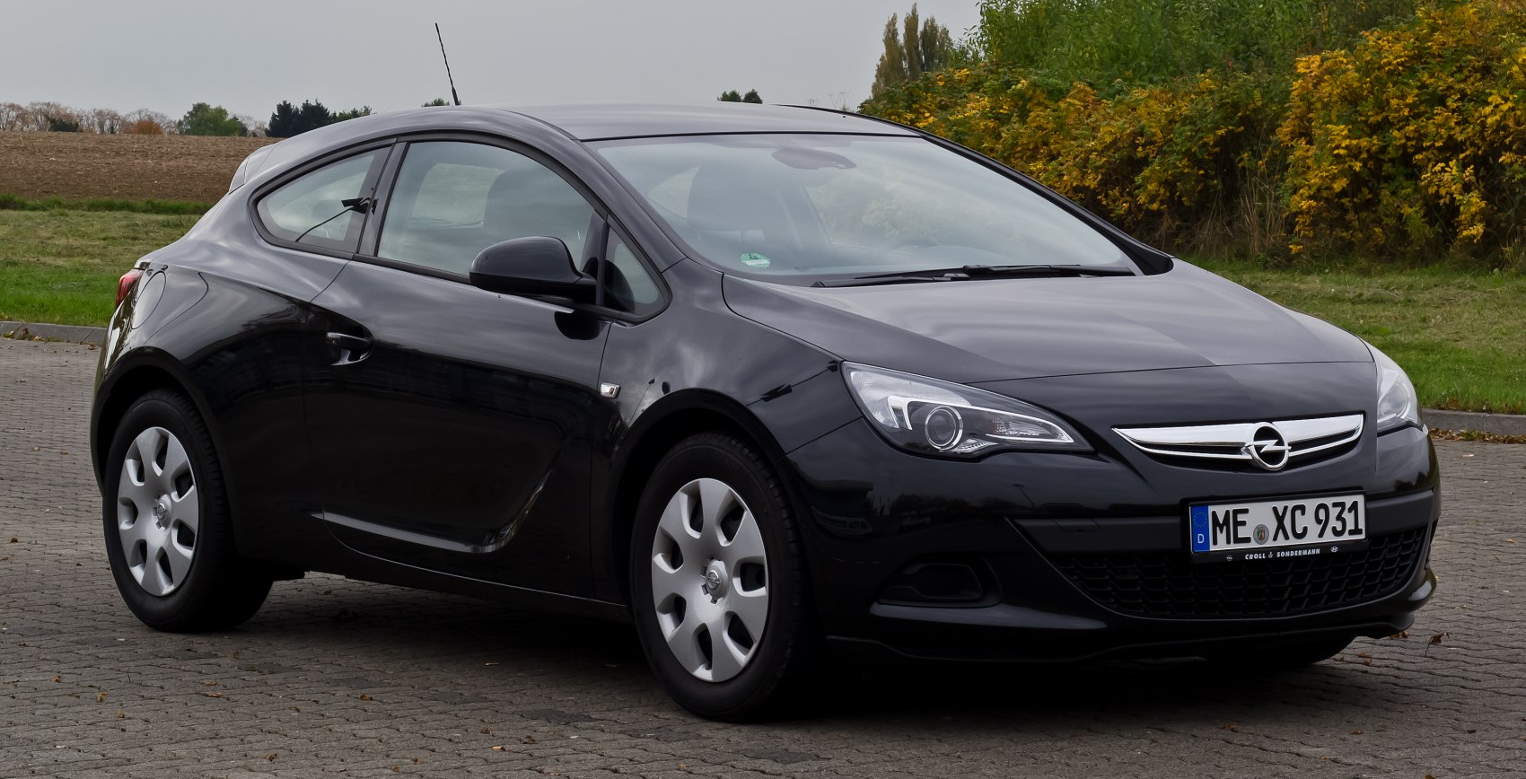 Black 3-door hatchback with projector headlights and sleek body lines