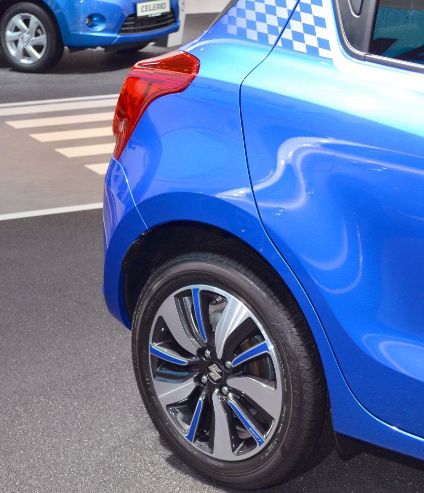 Rear side with alloy wheel and taillight of a blue hatchback.