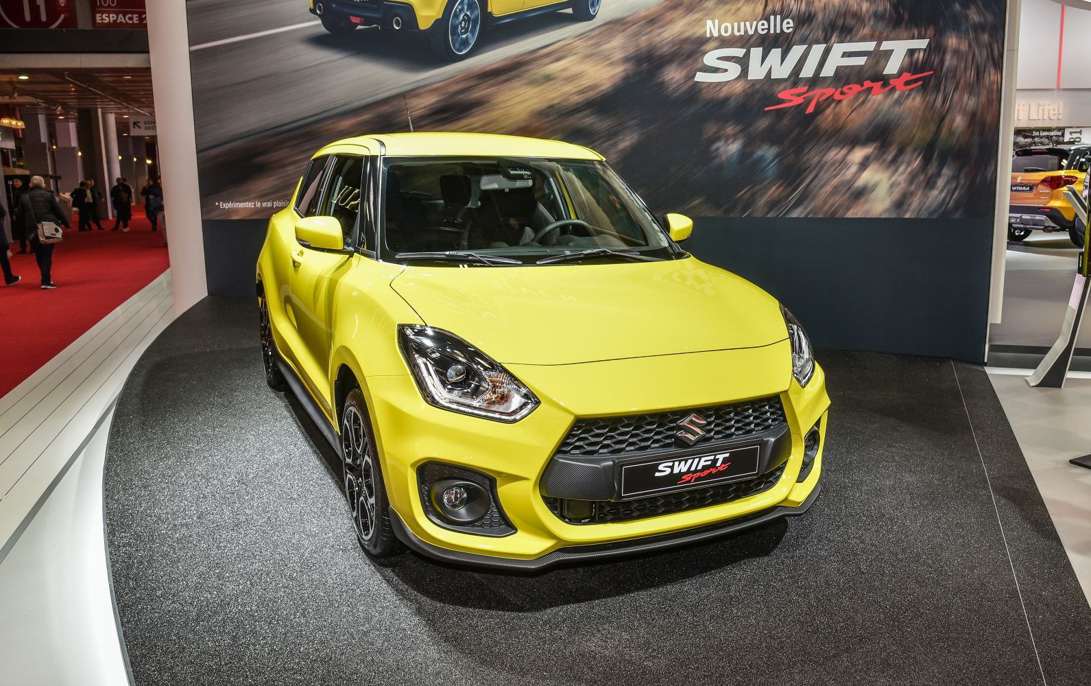 Sporty front grille and headlights of a yellow compact hatchback