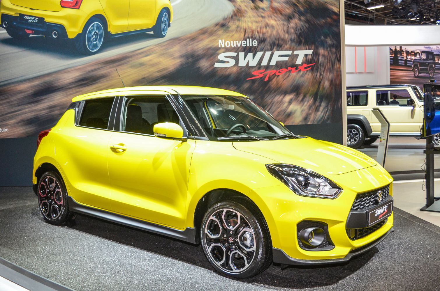 Yellow sporty compact hatchback with aggressive front and alloy wheels