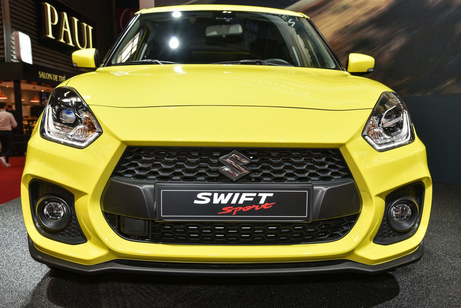 Front grille and headlights of a yellow sporty hatchback