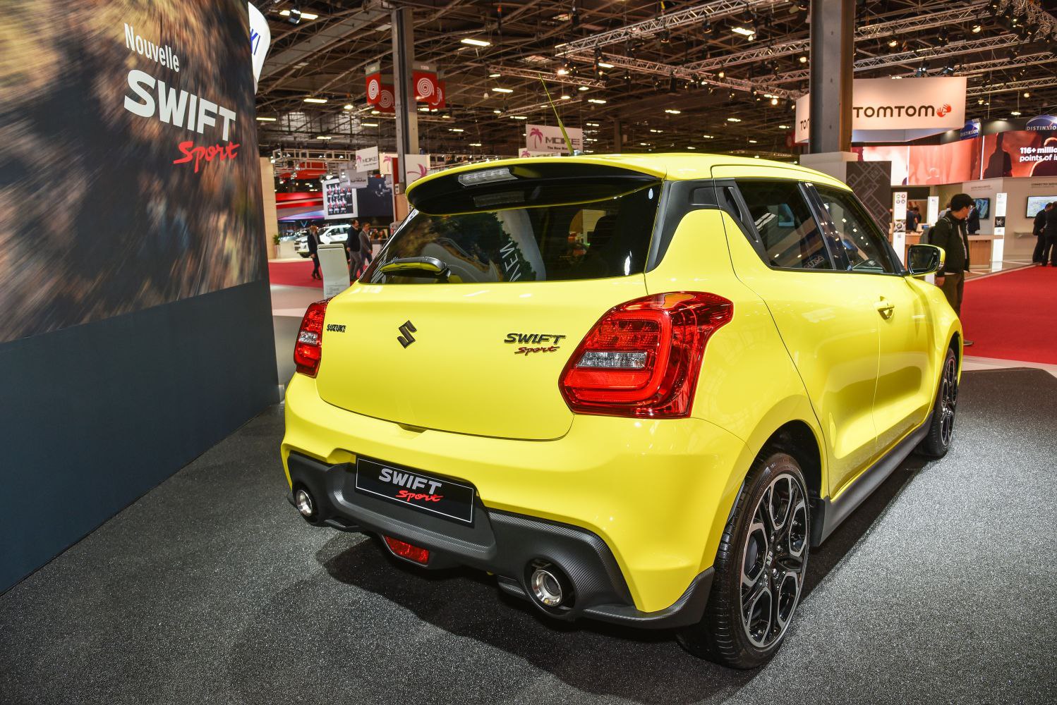 Rear and side sporty hatchback view with dual exhausts and alloy wheels.