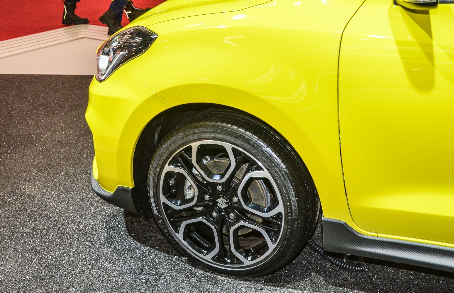 Alloy wheel and yellow front fender of a modern hatchback