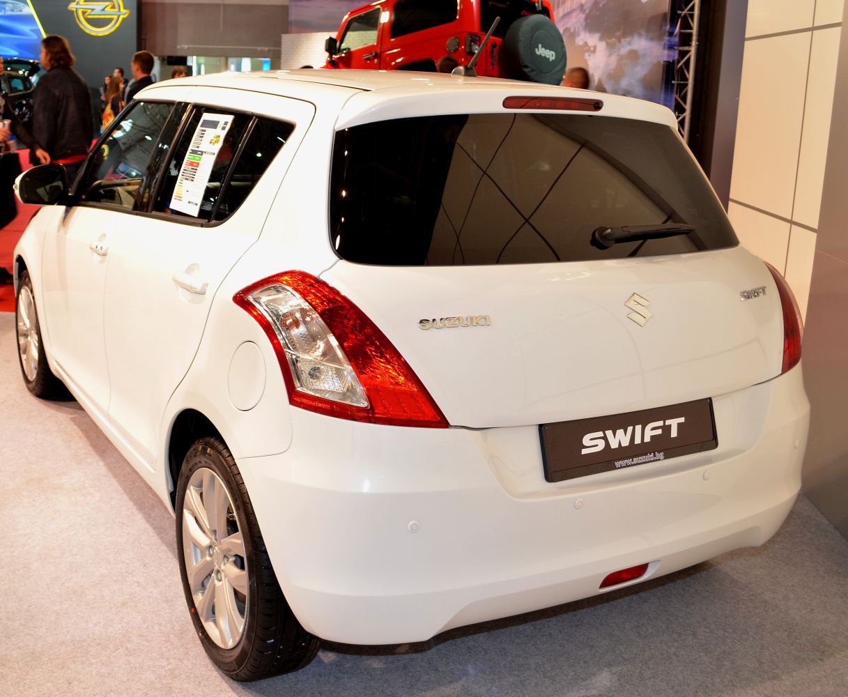 Rear and side view of a white hatchback with distinctive taillights