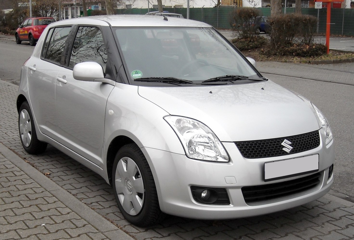 Compact hatchback with rounded headlamps and honeycomb grille