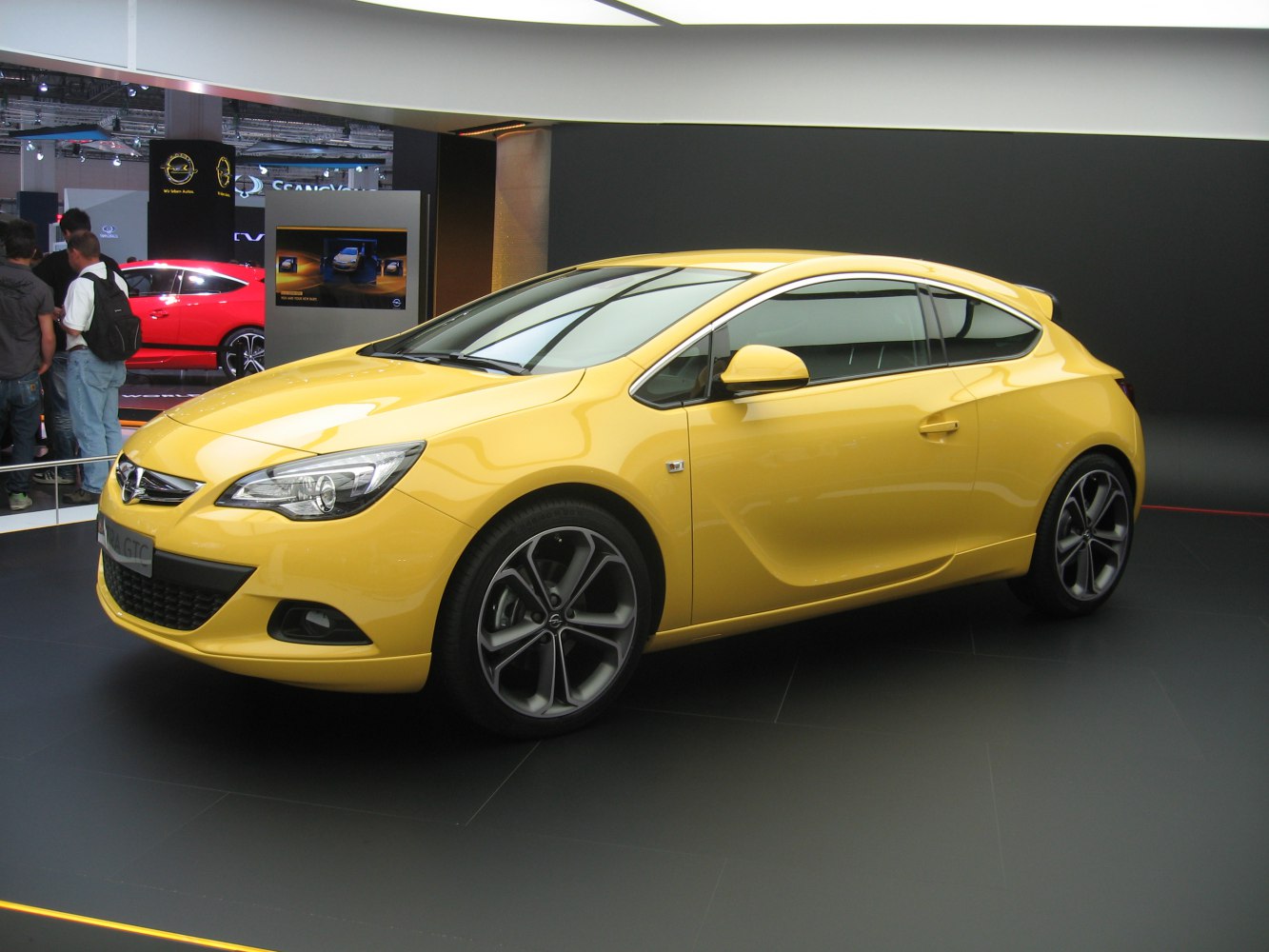 Yellow sporty compact coupe with LED headlights and alloy wheels.