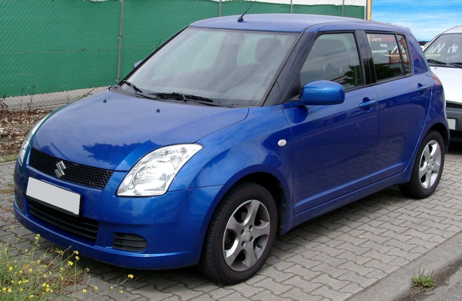 Compact hatchback with rounded headlights and five-spoke wheels
