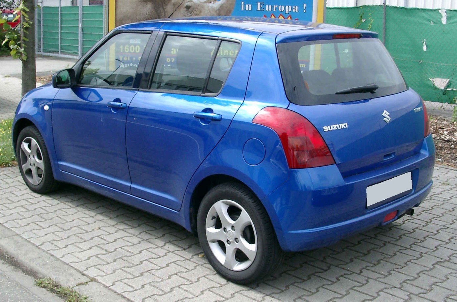 Blue compact hatchback with rear side and tail light focus