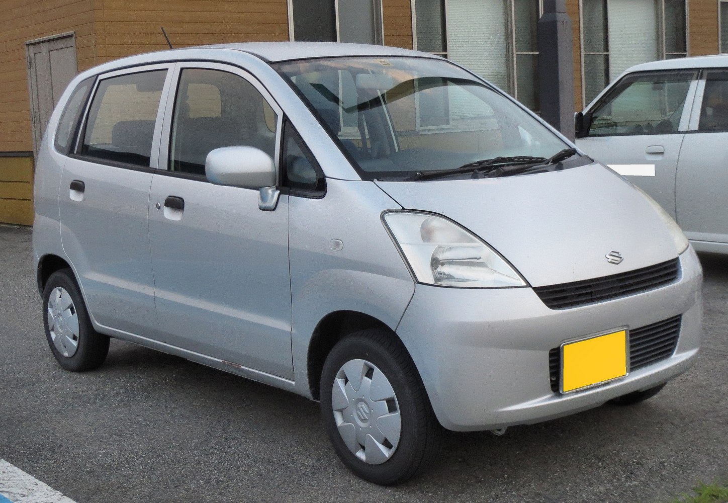 Silver compact hatchback with rounded headlights and five doors