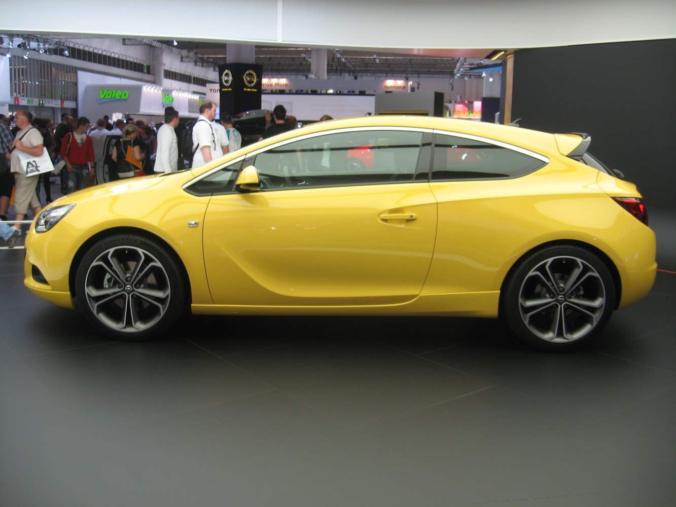 Yellow 2-door sporty compact hatchback with alloy wheels and sleek design