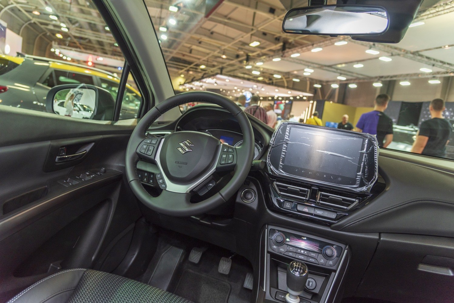 Touchscreen infotainment and manual gear lever in modern vehicle interior