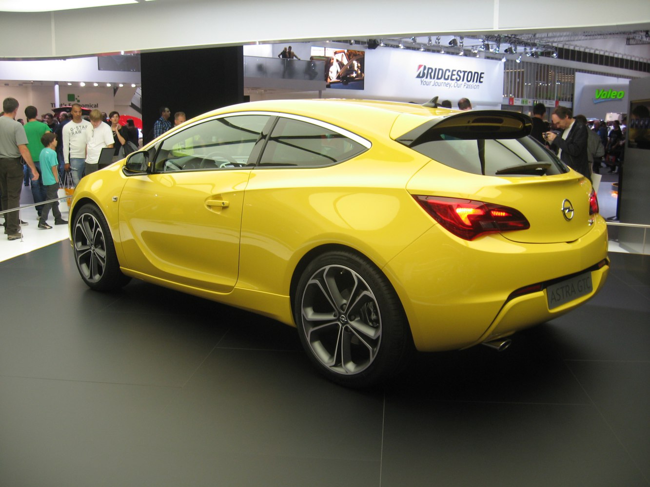 Yellow sporty hatchback with sleek rear design and modern lighting