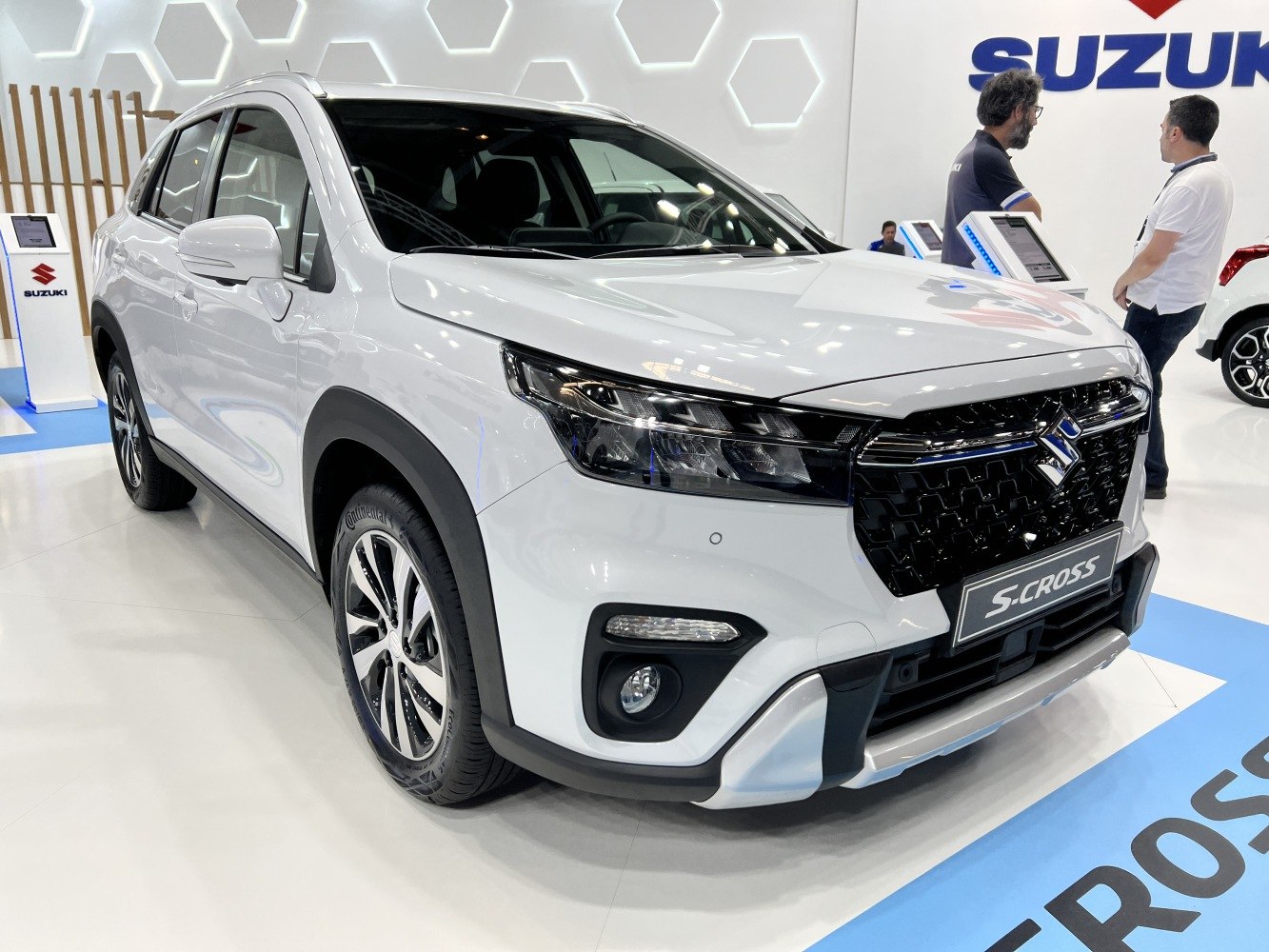 Front angled view of white crossover with black grille and sleek headlights
