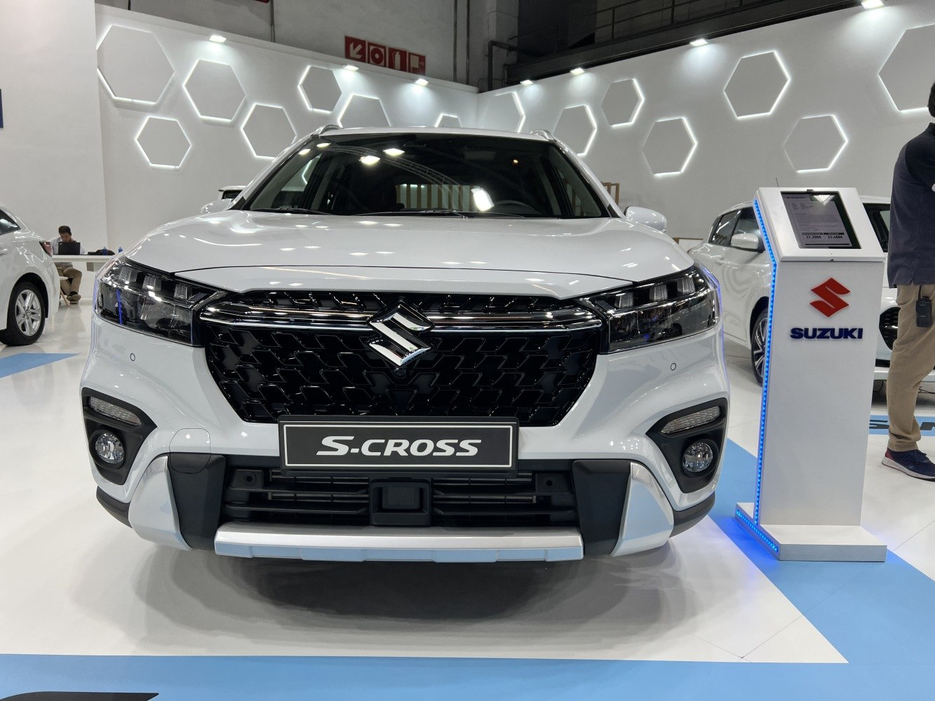 Black hexagonal grille and sleek headlamps on SUV front view