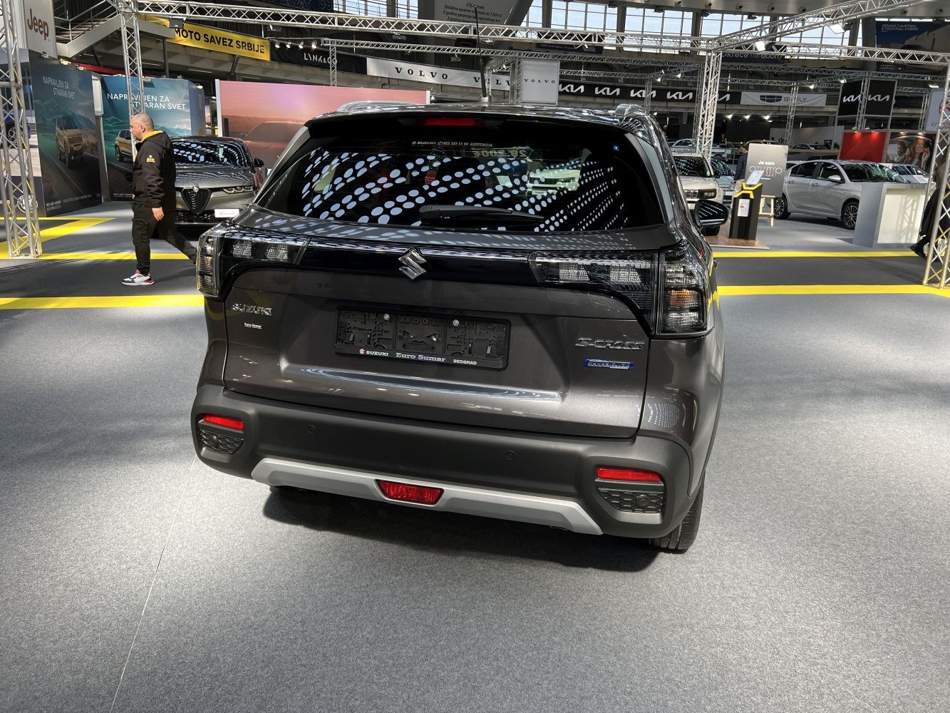 Rear view with hybrid badge, LED tail lights, and sculpted rear bumper