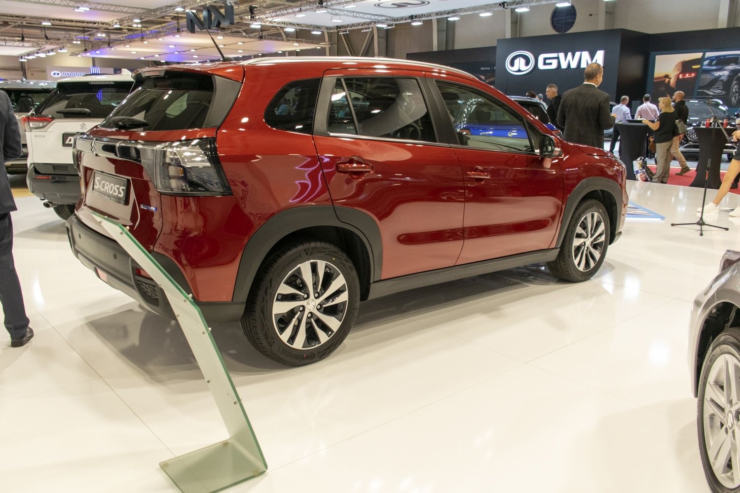 Red SUV viewed from rear and side with alloy wheels