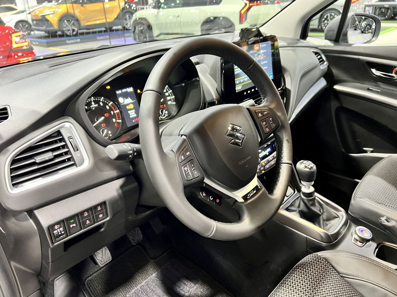 Manual transmission and multifunction steering wheel in modern car interior