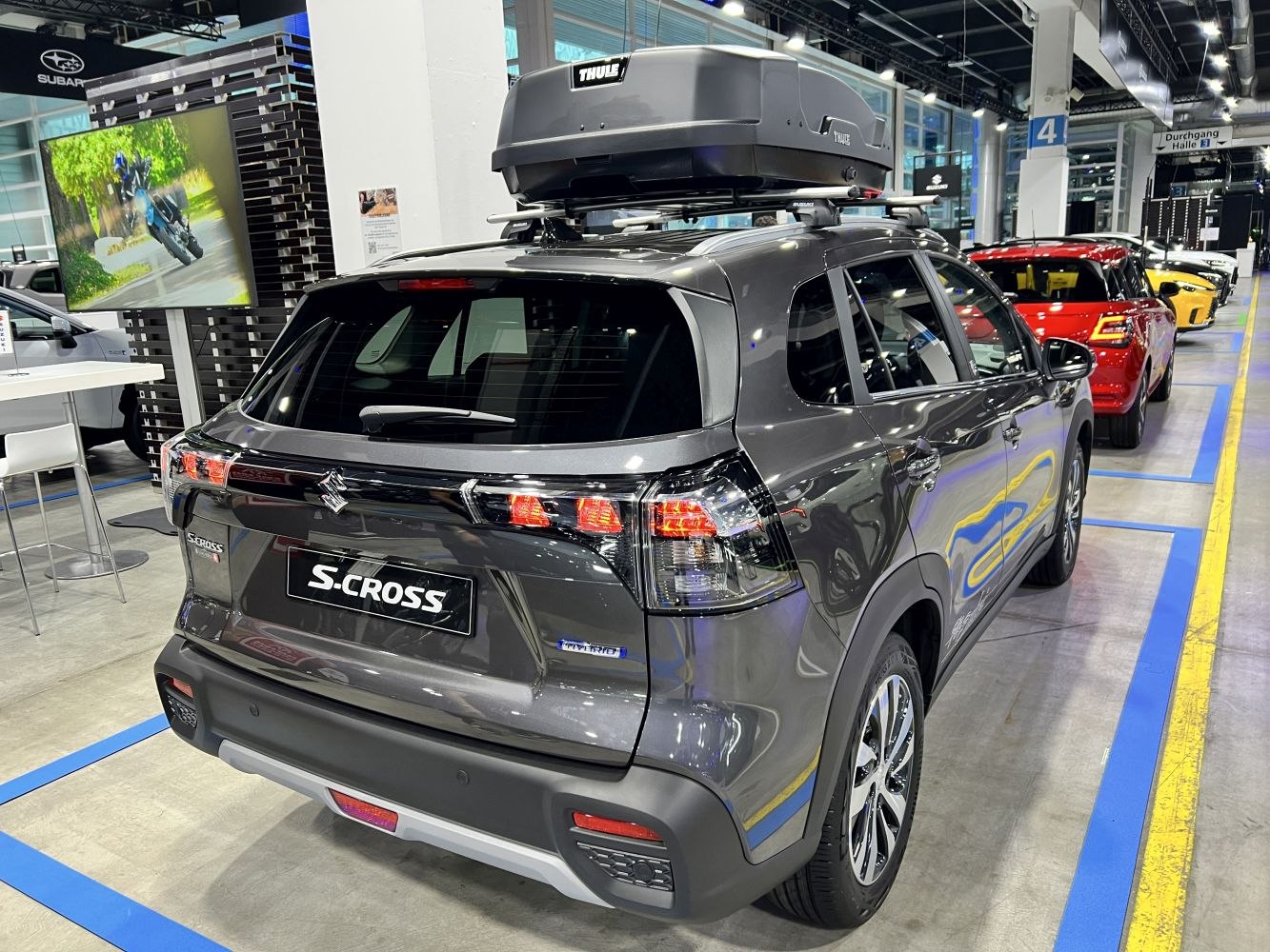Rear view with LED taillights and roof box on a modern SUV